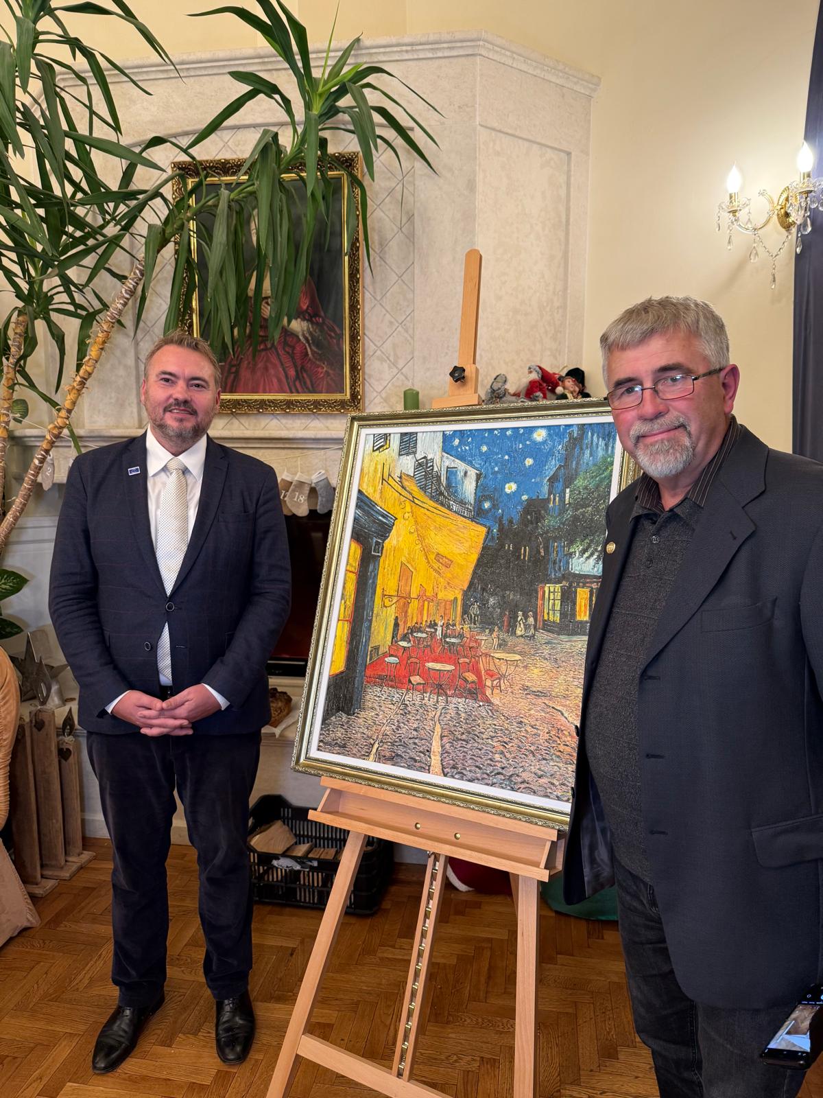 Artist Mircea Codrea introducing to the audience the HCR mission statement - a reproduction of the famous painting of Vincent Van Gogh - Cafe Terrace by Night